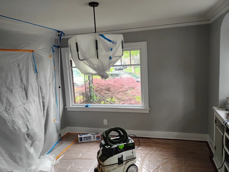 Interior room with plastic sheeting containment and dust extraction equipment