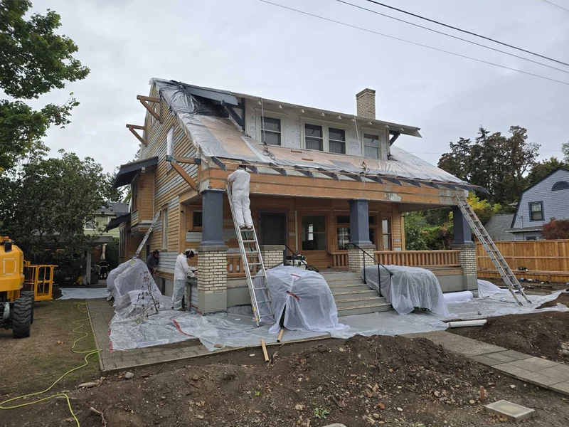 Major renovation showing roof and siding removal with lead paint abatement